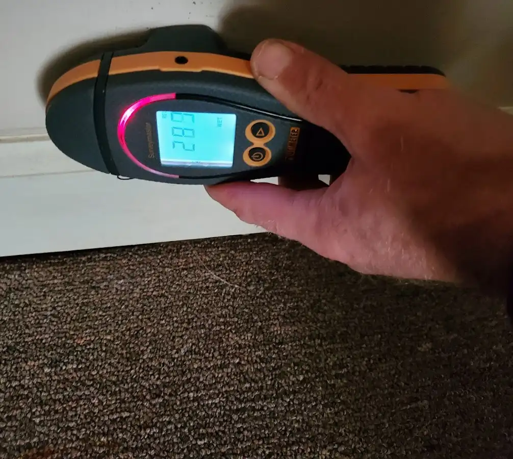 Moisture detection at baseboard during Storm Damage Restoration in Watertown